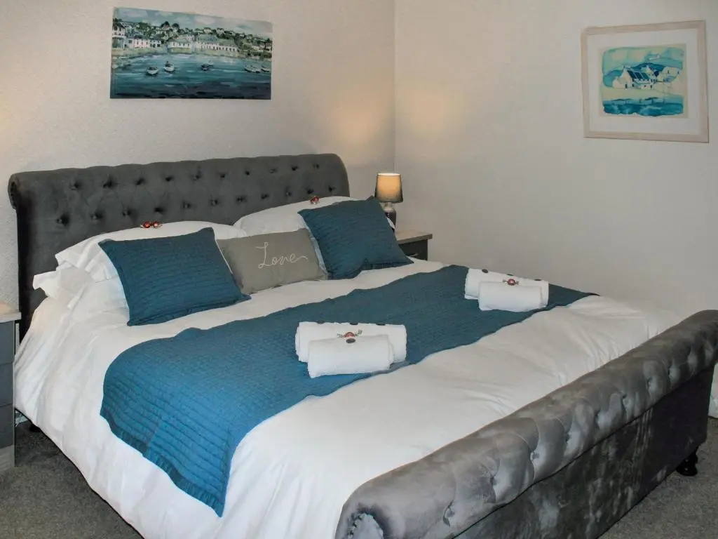 a large bed in a bedroom with blue and white at Harbour Road in Gardenstown