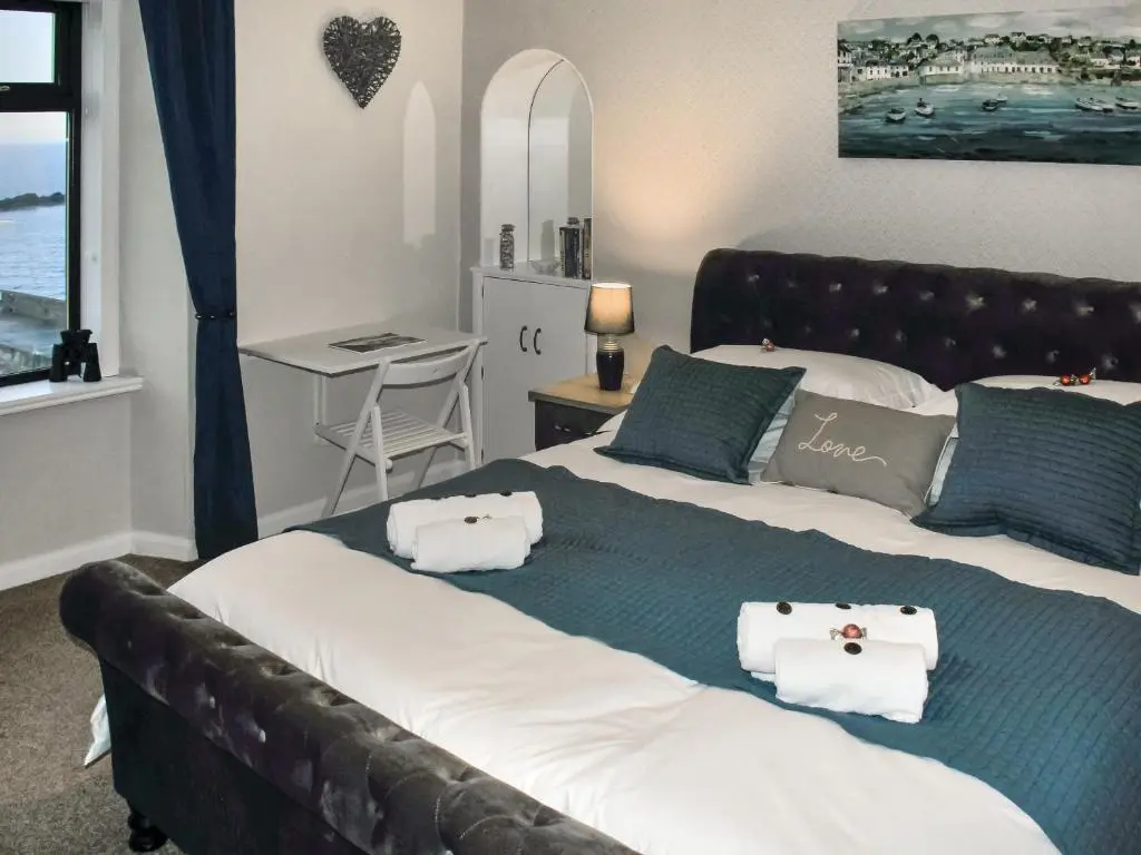 a bedroom with two beds with towels on them at Harbour Road in Gardenstown
