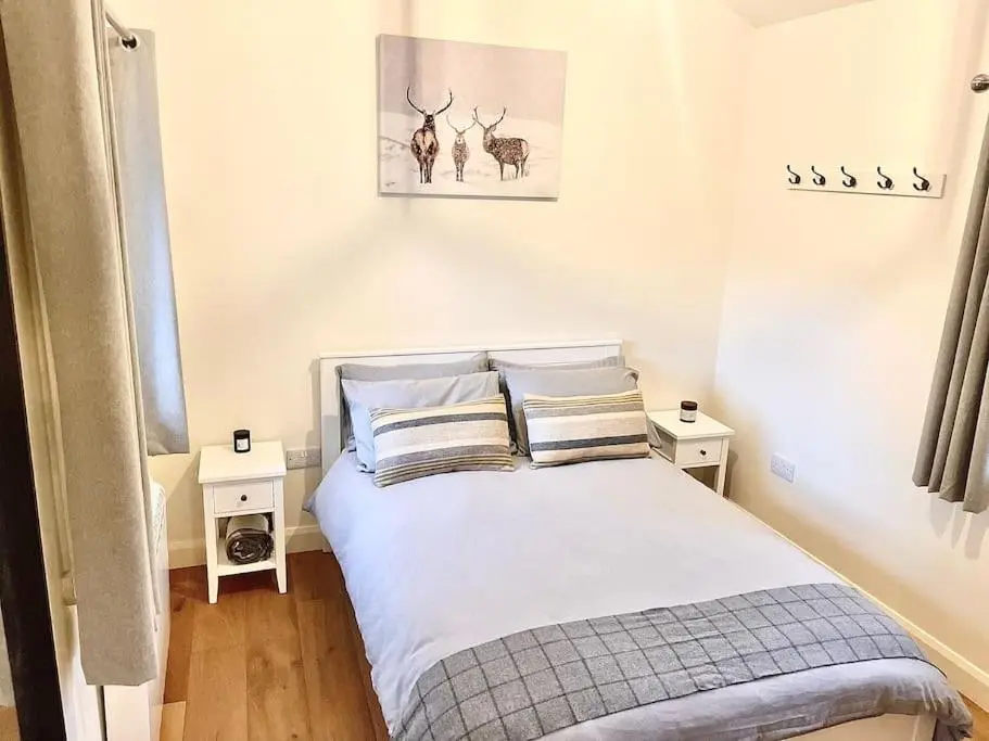 a bedroom with a bed with two night stands at The Old Croft in Fort Augustus