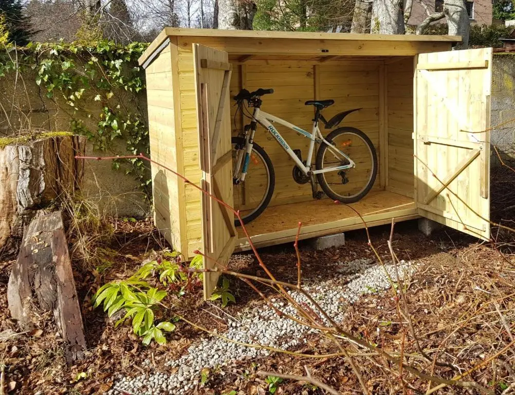 a bike is parked in a wooden shed at Baltinna West - by Where Stags Roar in Newtonmore