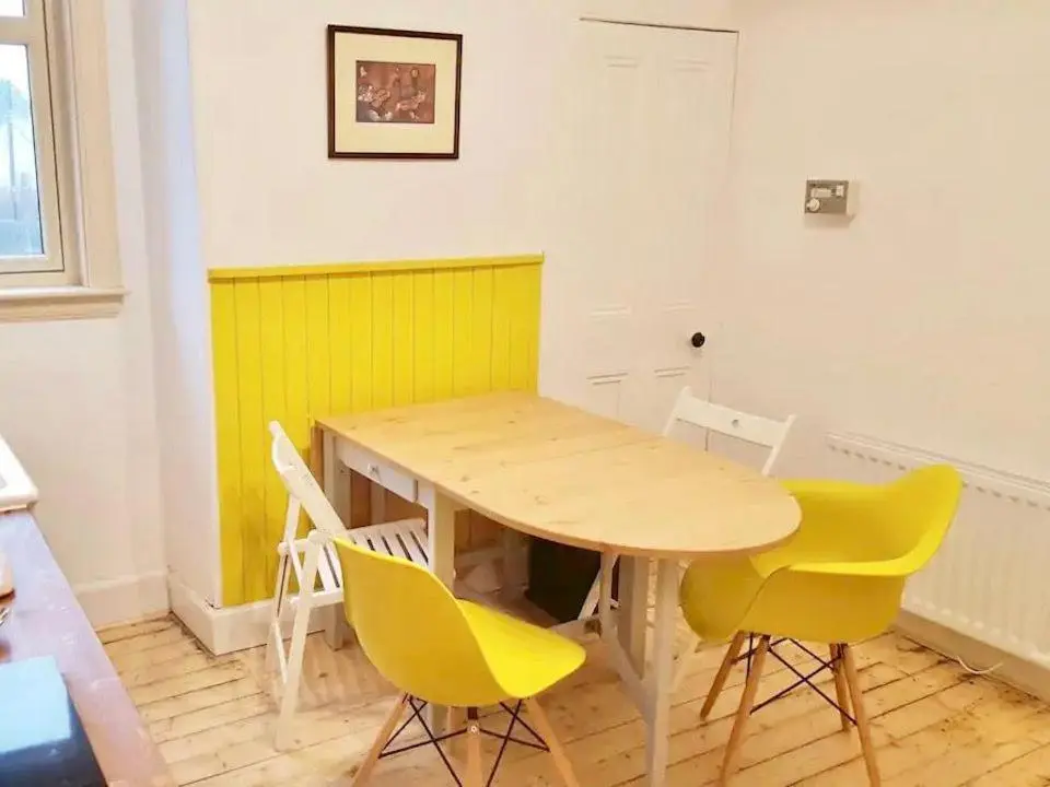 a wooden table and chairs in a room at Caman House Apt 2 - by Where Stags Roar in Newtonmore