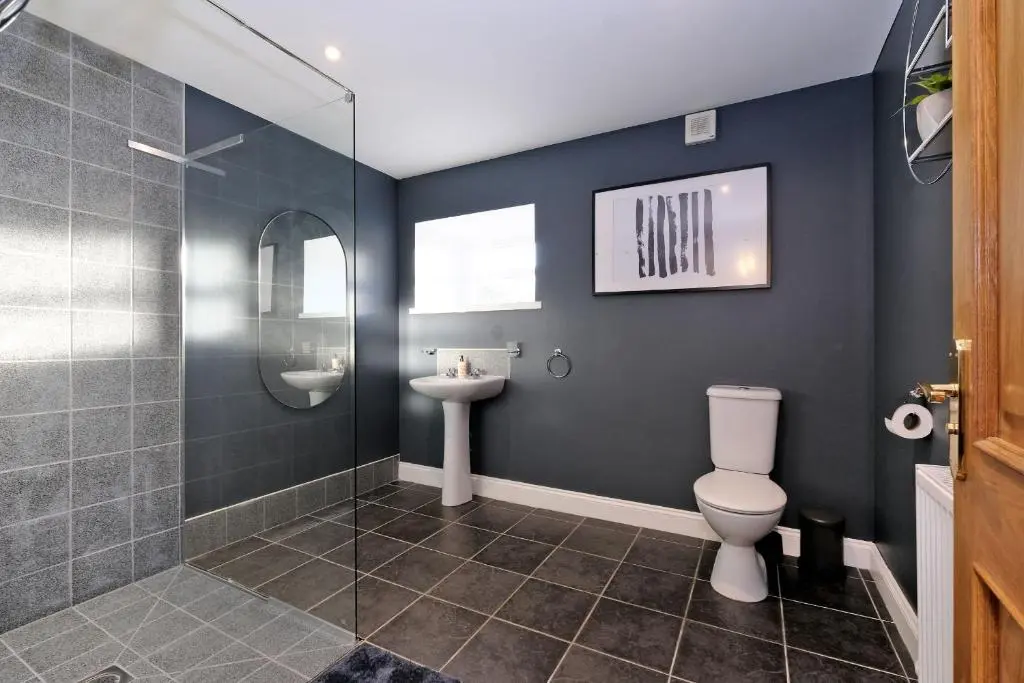 a bathroom with a shower and a toilet and a sink at Rosebrae in Insch
