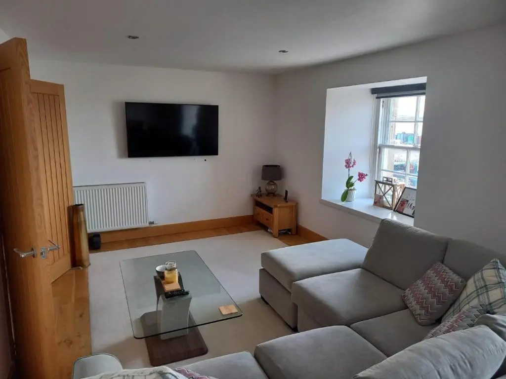 a living room with a couch and a table at Telford Escape in Elgin