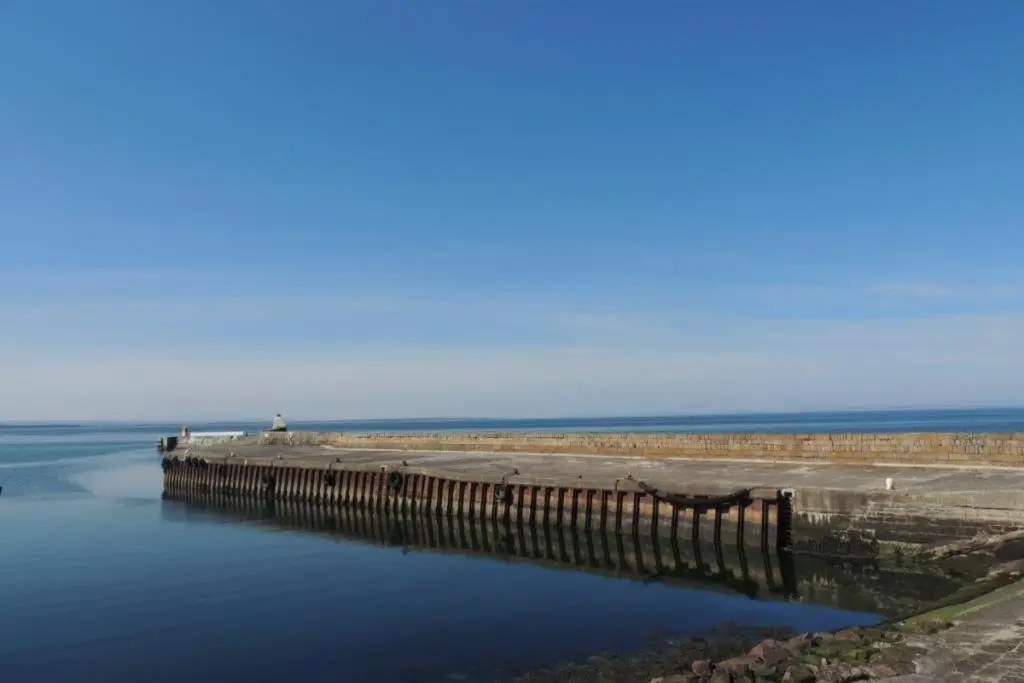 a pier in the water with the ocean in the background at Telford Escape in Elgin