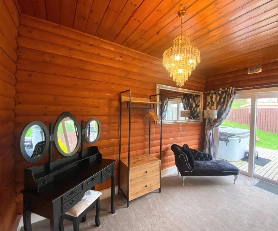 a room with a vanity and a chair and a chandelier at Kaoglen Warren - Pet friendly - Hot Tub - Cairngorms in Blairgowrie
