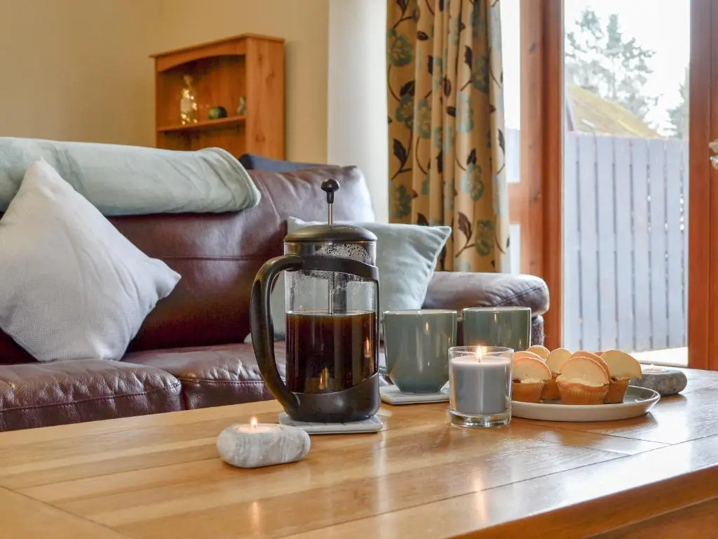 a coffee pot on a table with food on it at Old Mill Cottage in Blair Atholl