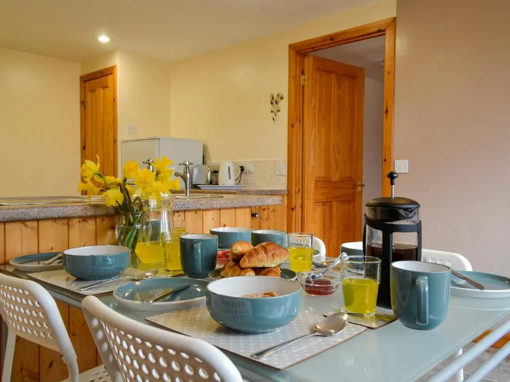 a table with bowls of food on it in a kitchen at Old Mill Cottage in Blair Atholl