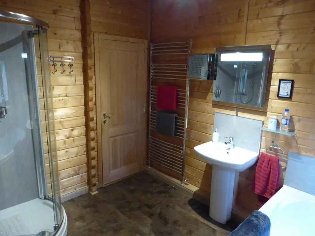 a bathroom with a sink and a shower and a toilet at Cairnhill Lodge - Award-Winning Luxury Highland Retreat in Blairgowrie