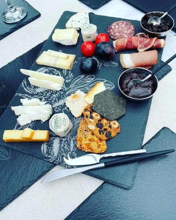a plate of cheese and other foods on a table at Clachan Garden B&B in Garve