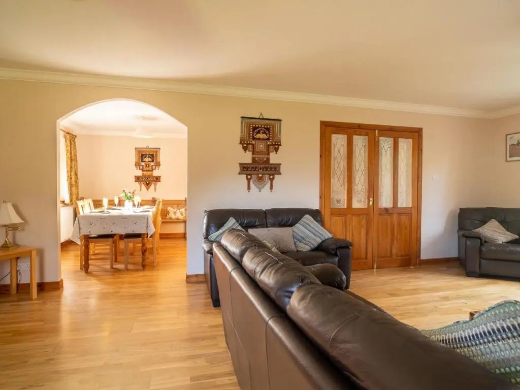 a living room with a couch and a table at Holiday Home Ceilidhtail Cottage by Interhome in Drumnadrochit
