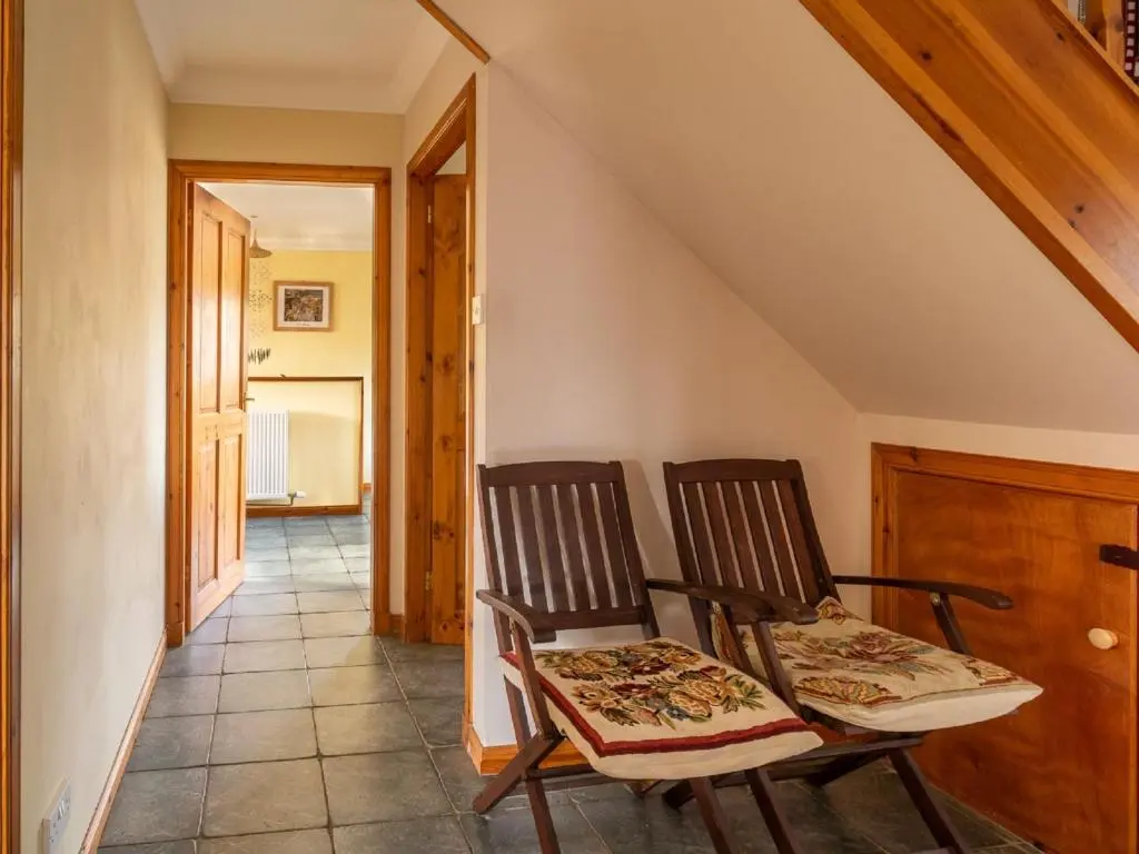 two chairs sitting in a room with a hallway at Holiday Home Ceilidhtail Cottage by Interhome in Drumnadrochit