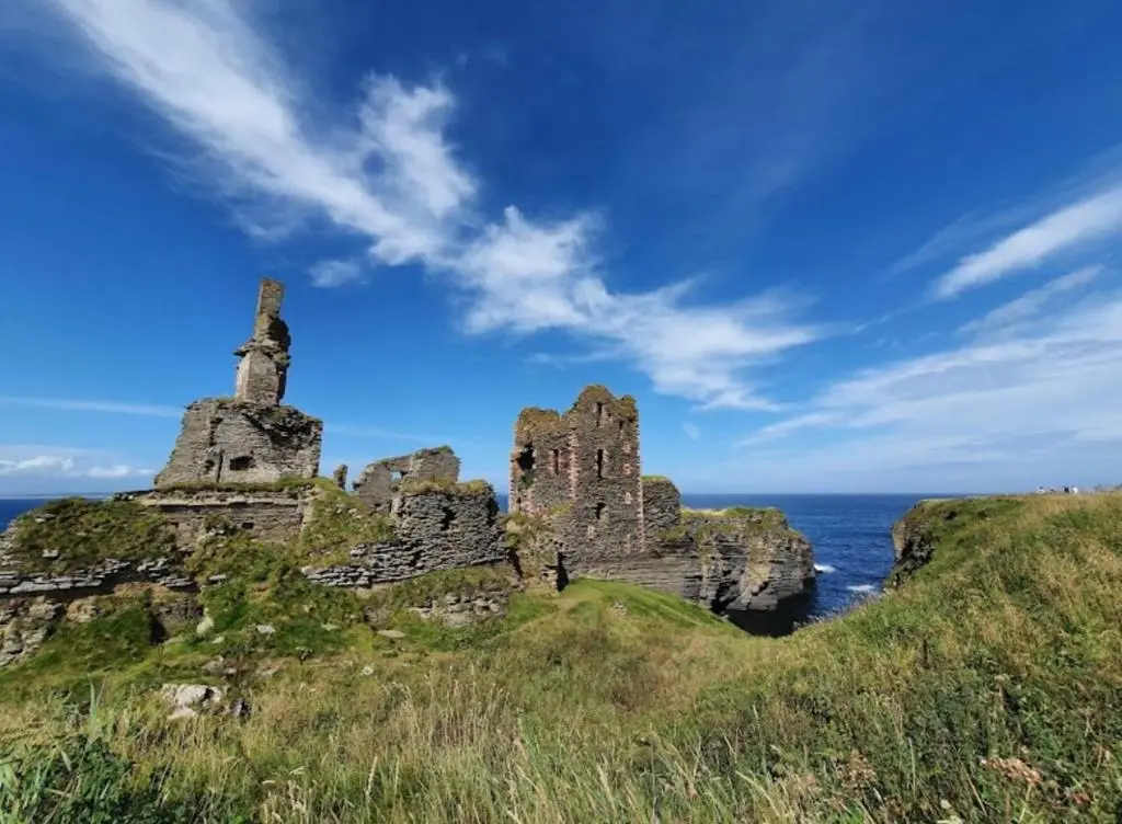 an old castle on a hill near the ocean at Farr North Lodge 1 By The Sea in Wick