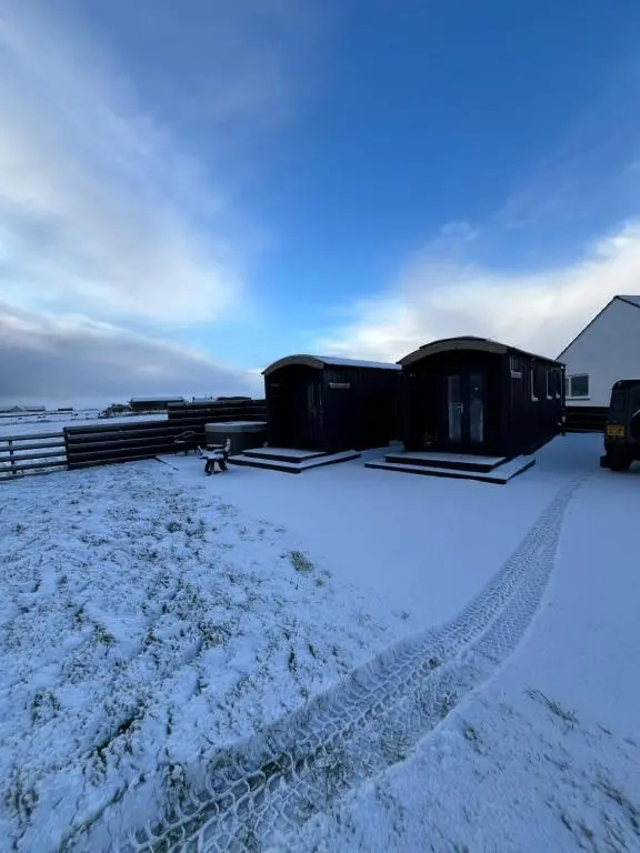 a snow covered yard with a couple of camping huts at Hot Tub Haven Farr North 2 in Wick