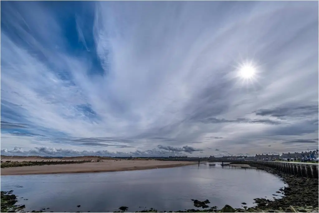 a body of water with the sun in the sky at Playa la Casa in Lossiemouth
