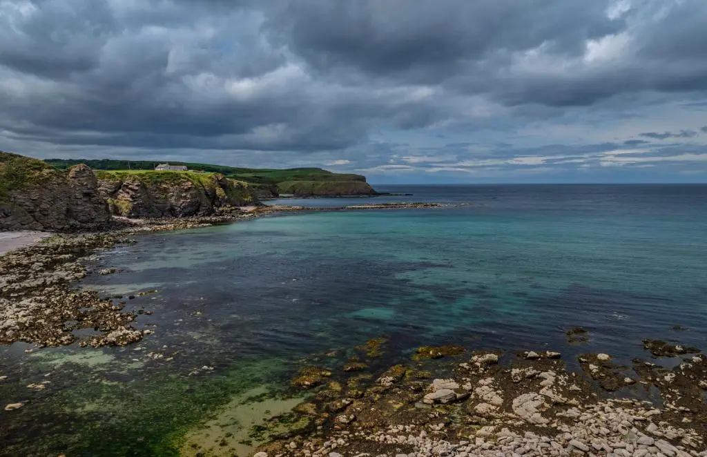 an aerial view of a beach with the ocean at Fisherman's Cottage in Pennan in Pennan