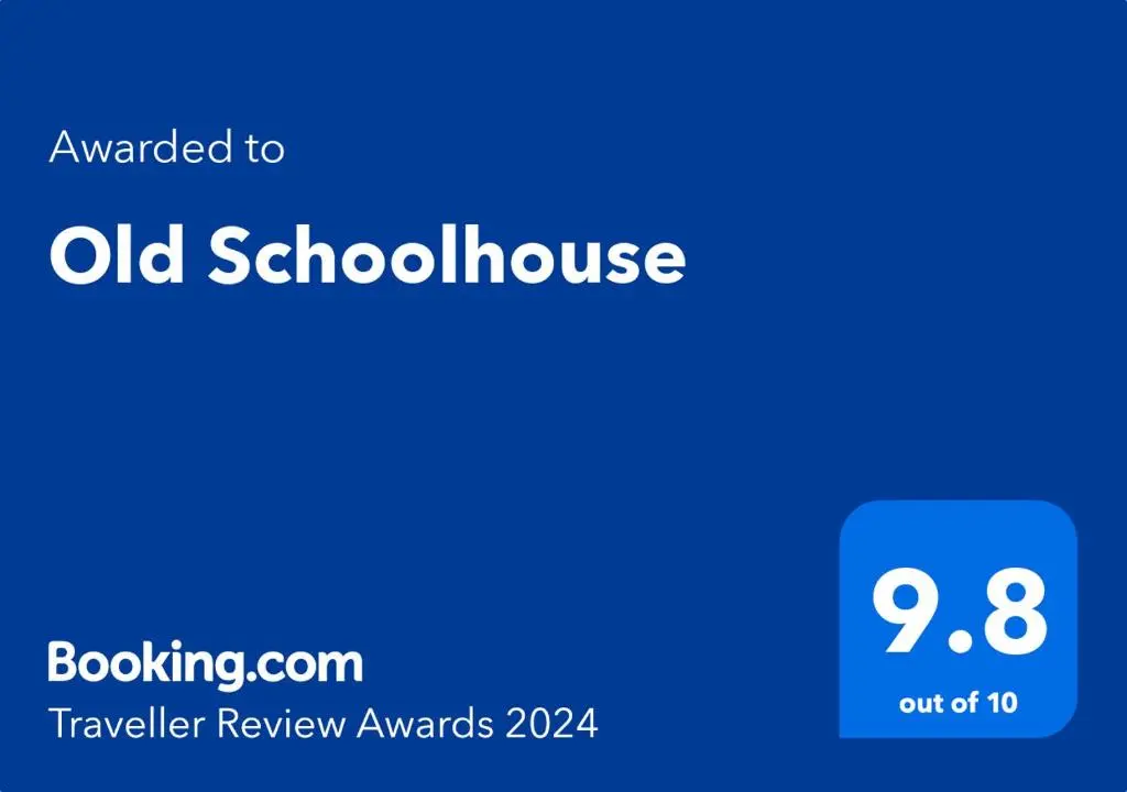 a blue sign with the words old school house on it at Old Schoolhouse in Lairg