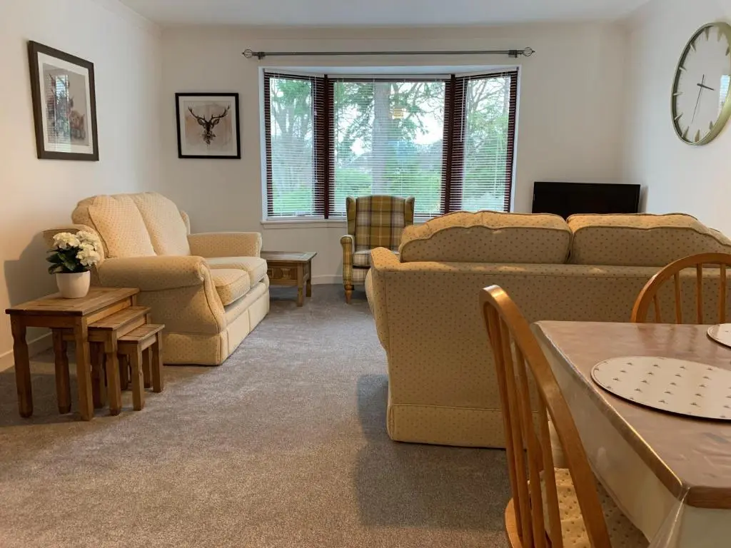 a living room with a couch and a table at No. 9 in Inverness