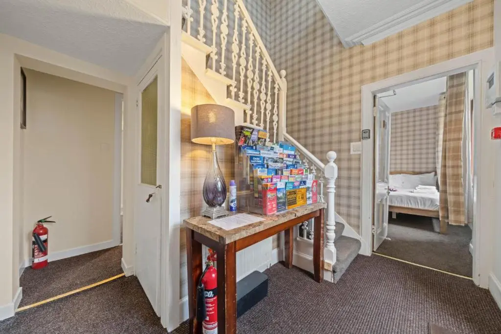 a hallway with a table with drinks on it at mySTAYINN Strathblane 7 Bedroom Full House - Inverness in Inverness