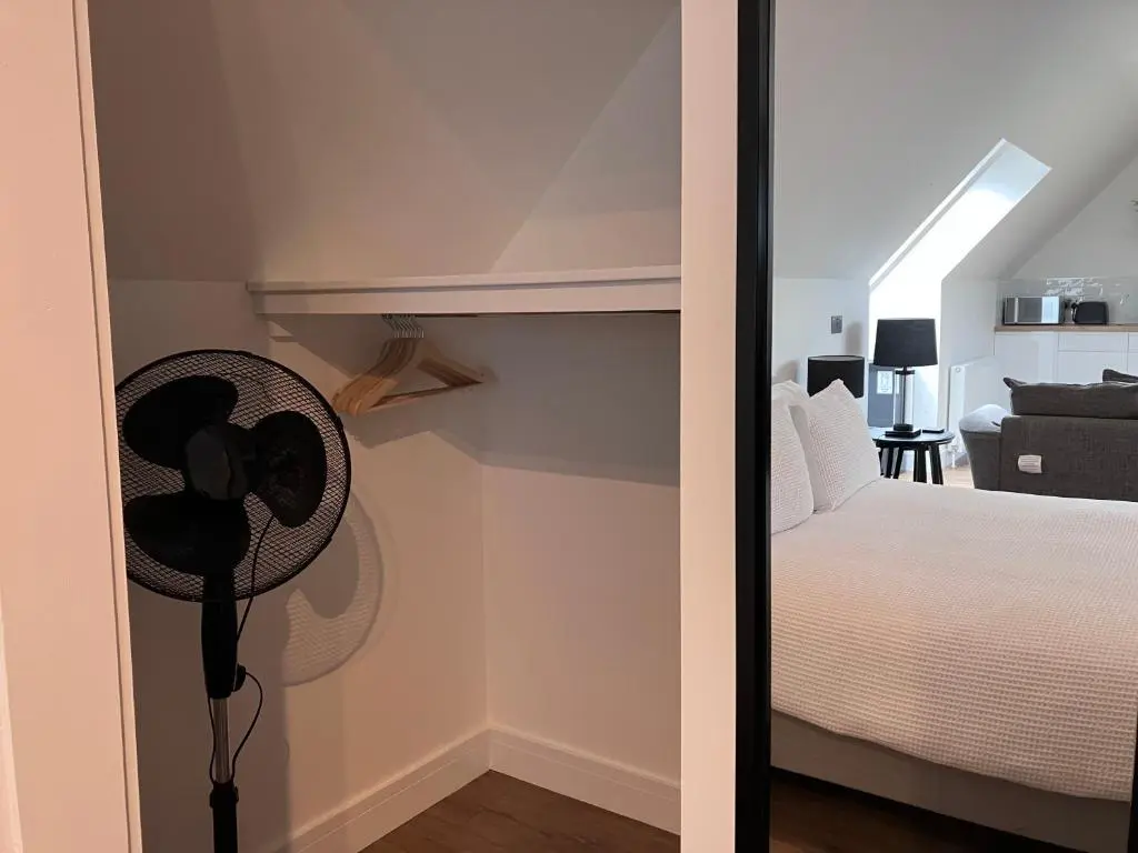 a room with a bed and a fan in a room at Berryfield Holiday Apartment in Inverness