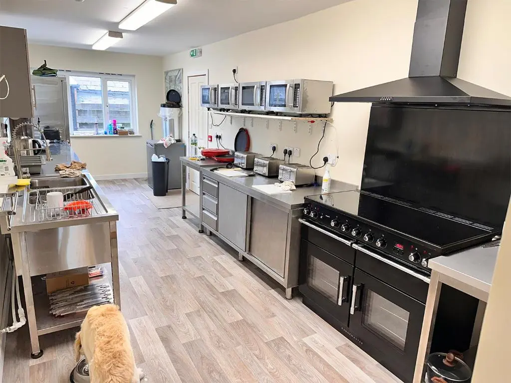 a large kitchen with a large stove top oven at Forces Manor in Kincraig