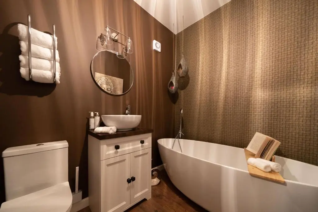 a bathroom with a white tub and a sink at Ranch House Cottage, Pet Friendly Stay, Inverurie in Thainstone