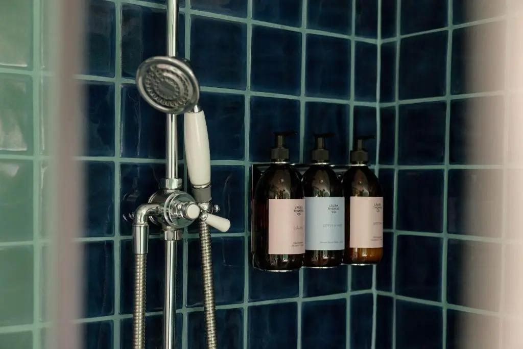 a shower with three bottles of wine and a blow dryer at Cuttieshillock in Banchory