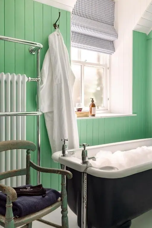a bathroom with a bath tub and a sink at Cuttieshillock in Banchory