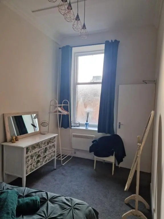 a bedroom with a mirror and a desk and a window at Baile Apartment Central Inverness in Inverness