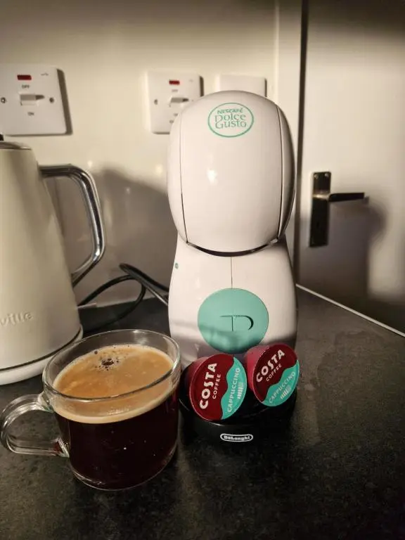 a coffee maker sitting next to a cup of coffee at Baile Apartment Central Inverness in Inverness