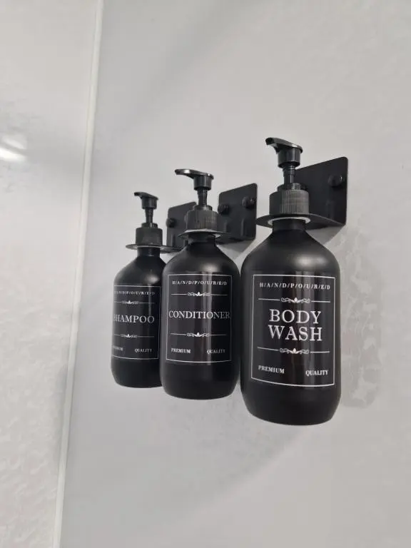 three bottles of body wash sitting on a shelf at Baile Apartment Central Inverness in Inverness