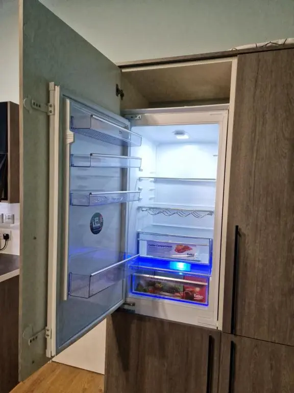 an empty refrigerator with its door open in a kitchen at Baile Apartment Central Inverness in Inverness