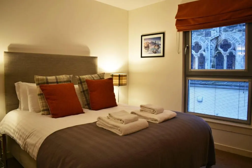 a bedroom with a large bed with towels on it at Cannon Point BW7 in Fort Augustus