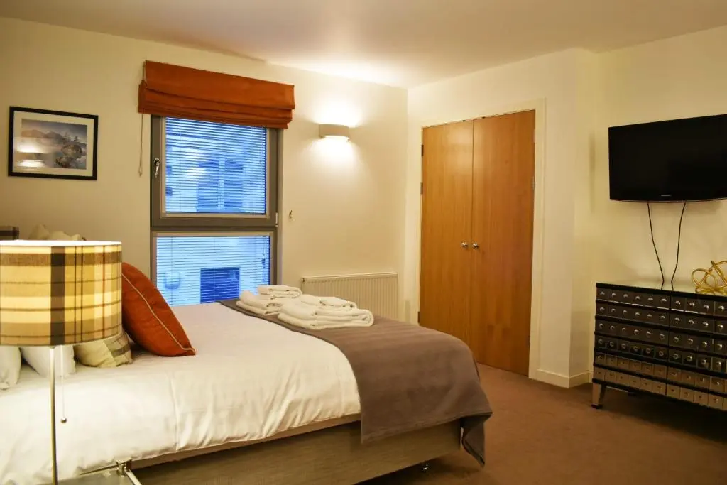a bedroom with a bed and a flat screen tv at Cannon Point BW7 in Fort Augustus