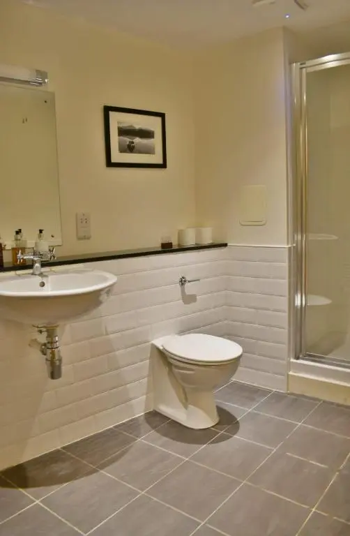 a bathroom with a toilet and a sink and a shower at Cannon Point BW7 in Fort Augustus