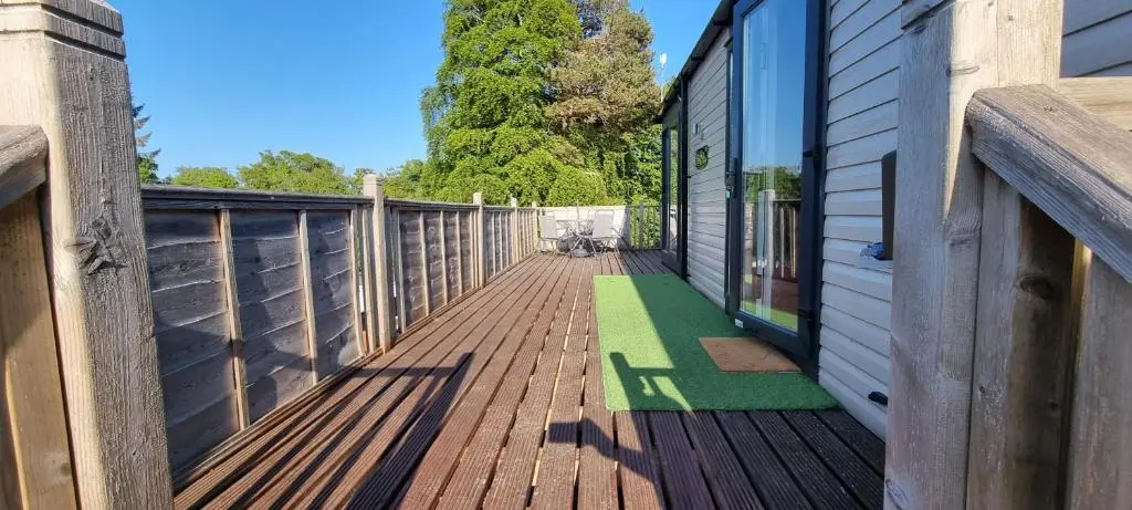 a wooden deck on a house at Lynton lodges in Evanton