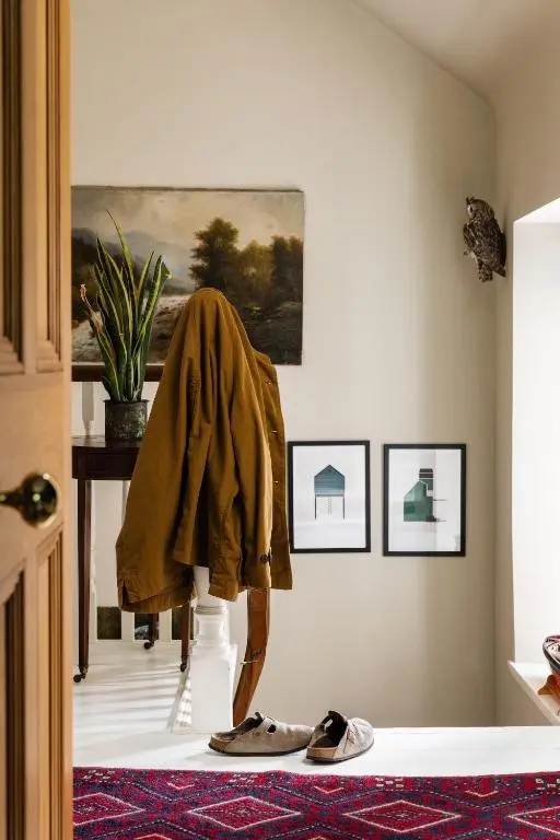 a room with a robe on a table and shoes at North Lodge & River Cabin in Banchory