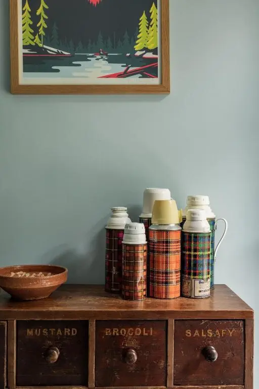 a wooden cabinet with several jars on top of it at North Lodge & River Cabin in Banchory