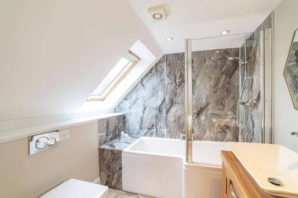 a bathroom with a sink and a bath tub at Mill House with Hot Tub in Cray