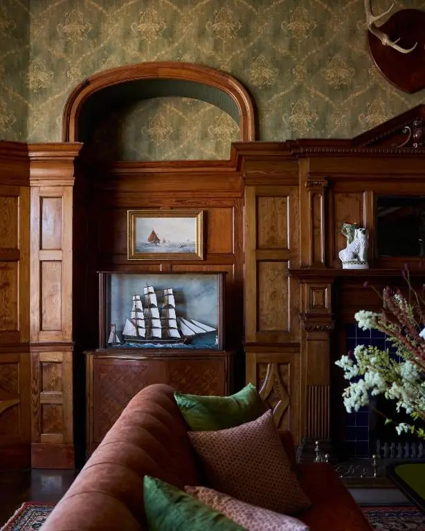 a living room with a couch and a fireplace at Dornoch Station in Dornoch