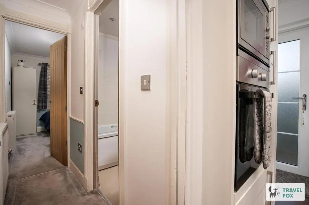 a room with a hallway with a door to a bathroom at Daisy Cottage - Two bed country retreat with hot tub in Turriff