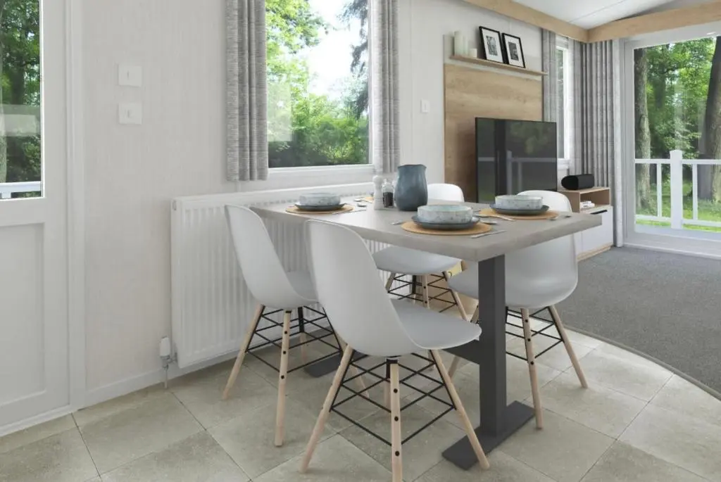 a dining room with a table and white chairs at The Springer Van - Beautiful, luxury static caravan in Aberlour