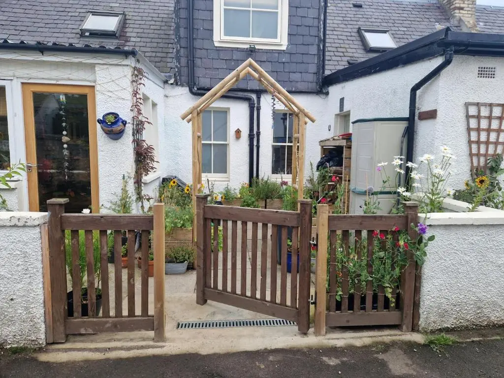 a wooden fence in front of a house at Room at the Back, 2 George Street in Avoch