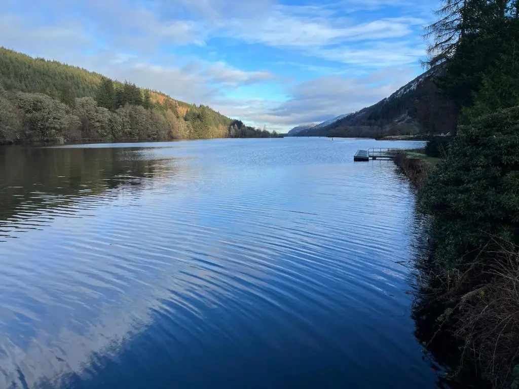 a view of a river with a boat on it at Caledonia Lodge in Spean Bridge