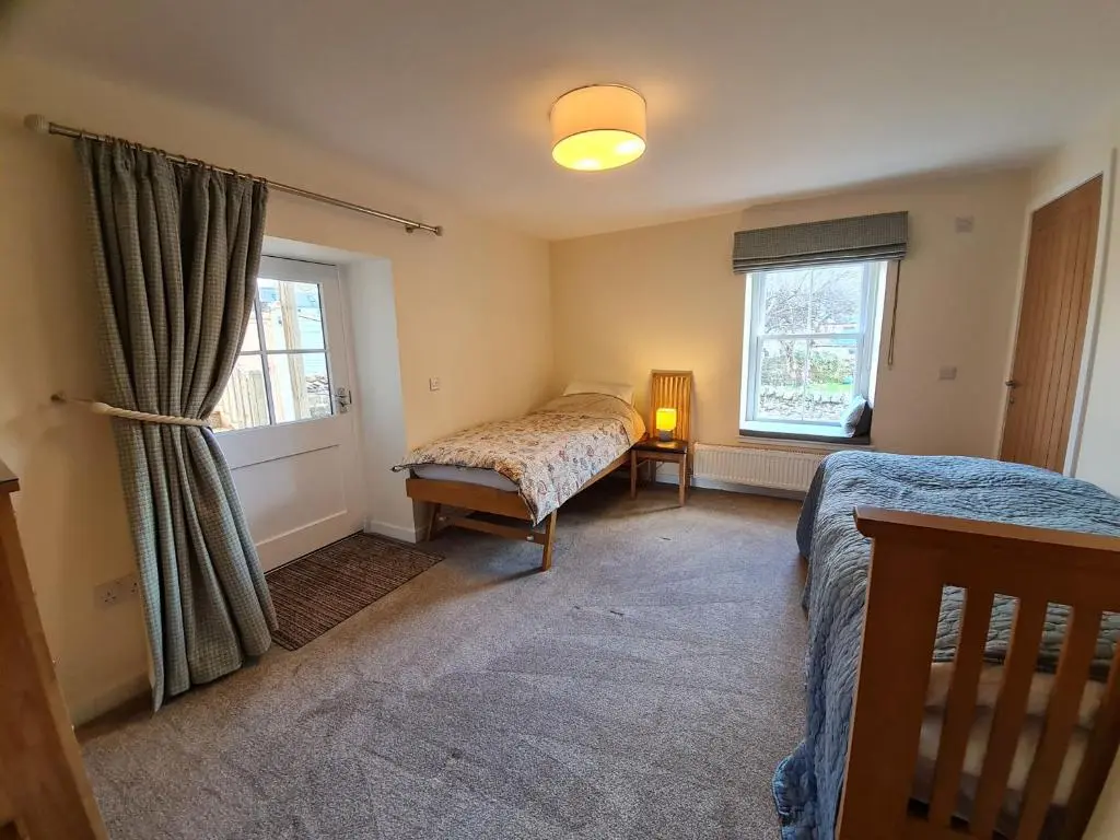 a bedroom with a bed and a window at Old Police Station, Portsoy in Portsoy