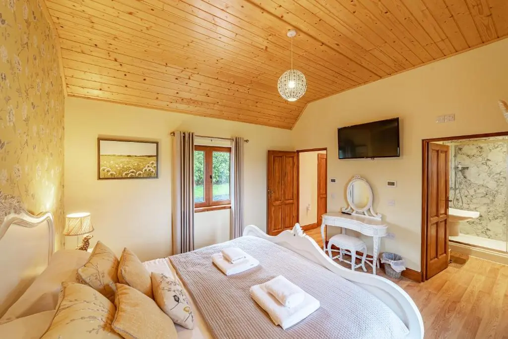 a bedroom with a large bed and a television at Wildcat Lodge in Cray