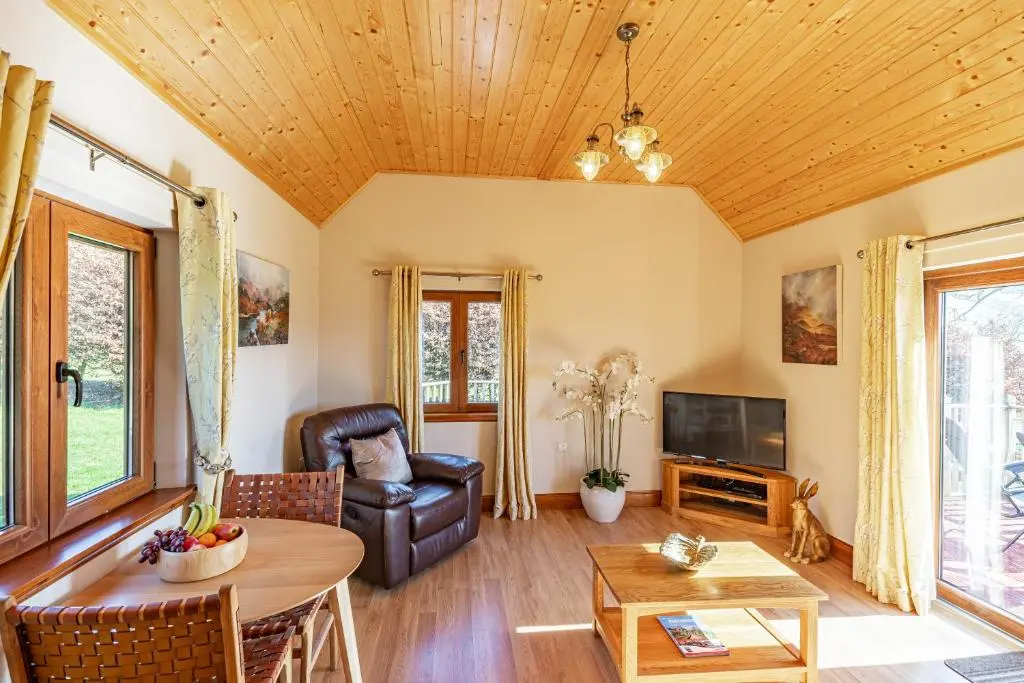 a living room with a couch and a table at Wildcat Lodge in Cray