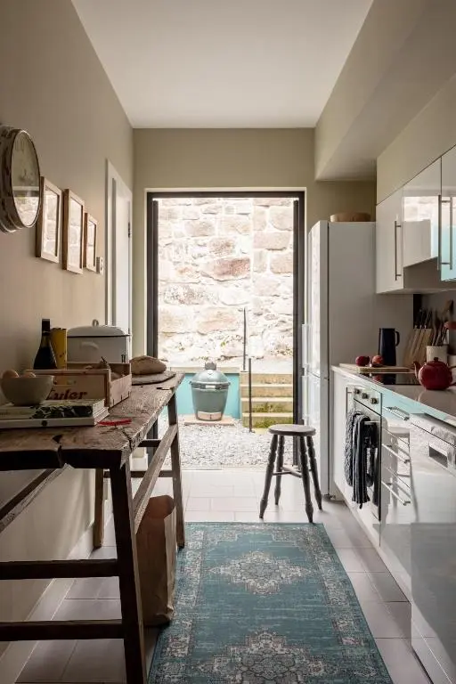 a kitchen with a table and a large window at Number 2 Steading Cottage in Banchory
