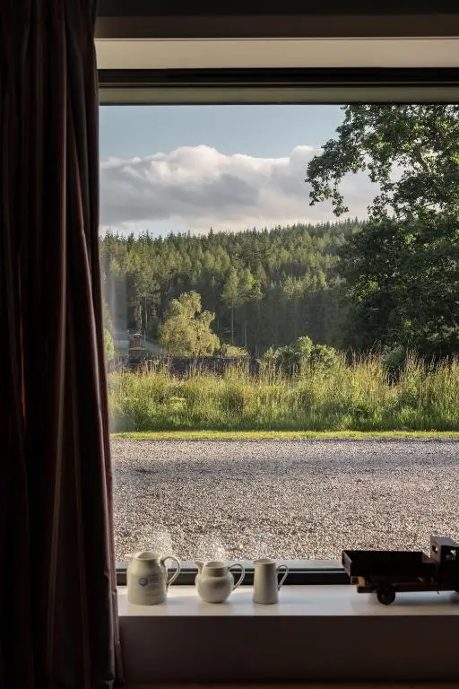 a window with a view of a road at Number 2 Steading Cottage in Banchory