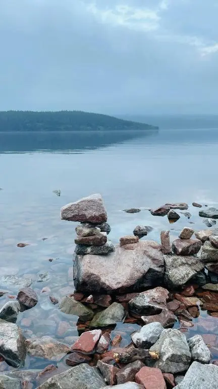 a pile of rocks sitting on top of a body of water at Loch Ness Hideaway Pod in Lewiston