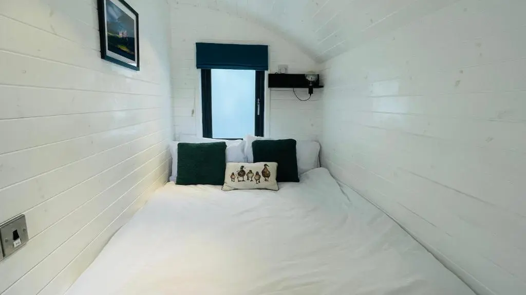 a small room with a bed in a house at Loch Ness Hideaway Pod in Lewiston